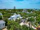 Wide aerial view of home with modern roof and lush landscaping at 3737 Bayou Louise Ln, Sarasota, FL 34242