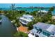 Wide aerial view of home on waterfront with boat dock and city views at 3737 Bayou Louise Ln, Sarasota, FL 34242