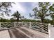 Rooftop balcony with decorative railing overlooking tropical foliage at 3737 Bayou Louise Ln, Sarasota, FL 34242