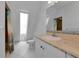 Well-lit bathroom with a unique window, updated vanity, and tiled floors at 3737 Bayou Louise Ln, Sarasota, FL 34242