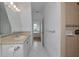 Well-lit bathroom featuring a single sink, tiled shower and white tile floors at 3737 Bayou Louise Ln, Sarasota, FL 34242