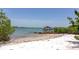 Sandy beach showing a private boat dock and waterfront views at 3737 Bayou Louise Ln, Sarasota, FL 34242