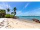 Private sandy beach showing gulf views and clear water at 3737 Bayou Louise Ln, Sarasota, FL 34242