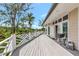 Spacious deck with white railings offering serene views and ample space for outdoor entertaining at 3737 Bayou Louise Ln, Sarasota, FL 34242