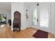 Inviting entryway with hardwood floors and decorative furnishings leading into other rooms at 3737 Bayou Louise Ln, Sarasota, FL 34242
