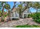 Charming two-story home with unique white railings surrounded by mature trees at 3737 Bayou Louise Ln, Sarasota, FL 34242