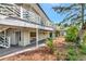 Home's exterior showcases a second story balcony and covered patio at 3737 Bayou Louise Ln, Sarasota, FL 34242