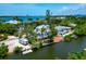 Stunning waterfront home featuring private dock, lush landscaping, and multiple balconies with ocean views at 3737 Bayou Louise Ln, Sarasota, FL 34242