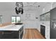 Stylish kitchen with white cabinets, stainless appliances, a gas cooktop, and a view of the backyard at 3737 Bayou Louise Ln, Sarasota, FL 34242