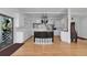 Spacious kitchen with white cabinetry, stainless steel appliances, and a black island with glass block accents at 3737 Bayou Louise Ln, Sarasota, FL 34242