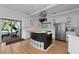 Modern kitchen with white cabinets, stainless steel appliances, a black island, and access to an outdoor space at 3737 Bayou Louise Ln, Sarasota, FL 34242