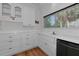 This kitchen features white cabinets and tile counter tops at 3737 Bayou Louise Ln, Sarasota, FL 34242