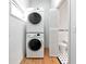 Efficient laundry area with stacked washer/dryer, adjacent to a half bathroom at 3737 Bayou Louise Ln, Sarasota, FL 34242