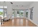 Bright living room with hardwood floors, French doors, and views of the surrounding greenery at 3737 Bayou Louise Ln, Sarasota, FL 34242