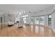 Expansive living room with wood floors, high ceilings, skylights, fireplace, and French doors to a balcony at 3737 Bayou Louise Ln, Sarasota, FL 34242