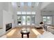 Bright living room with hardwood floors, skylights, fireplace, and access to outdoor deck at 3737 Bayou Louise Ln, Sarasota, FL 34242