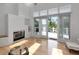 Bright living room featuring hardwood floors, a fireplace, and access to the outdoor deck at 3737 Bayou Louise Ln, Sarasota, FL 34242