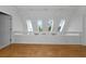 Hardwood floor in a loft featuring three large skylights and a modern railing at 3737 Bayou Louise Ln, Sarasota, FL 34242