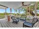 Inviting porch with wicker seating, a ceiling fan and picturesque views of the surrounding landscape at 3737 Bayou Louise Ln, Sarasota, FL 34242