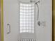 Bright shower with white tile surround and glass block window for natural light at 3737 Bayou Louise Ln, Sarasota, FL 34242