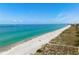 Beautiful aerial view of a sandy beach meeting a crystal clear blue ocean at 3802 Gulf Of Mexico Dr # A205, Longboat Key, FL 34228