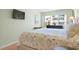 Bright bedroom with a beach-themed comforter, TV, and chest of drawers at 3802 Gulf Of Mexico Dr # A205, Longboat Key, FL 34228