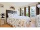 Cozy bedroom with natural light, stylish decor, and a comfortable queen size bed at 3802 Gulf Of Mexico Dr # A205, Longboat Key, FL 34228
