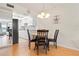 Cozy dining area featuring a chandelier and seating for four, next to kitchen at 3802 Gulf Of Mexico Dr # A205, Longboat Key, FL 34228