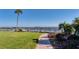 A brick paved path near a dock with boats, palm trees, and lush landscaping at 3802 Gulf Of Mexico Dr # A205, Longboat Key, FL 34228