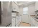 Contemporary kitchen with stainless steel appliances, white cabinets, and updated finishes at 3802 Gulf Of Mexico Dr # A205, Longboat Key, FL 34228