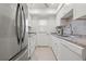 Updated kitchen with modern stainless steel appliances, white cabinets, and sleek countertops at 3802 Gulf Of Mexico Dr # A205, Longboat Key, FL 34228