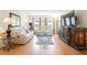 Bright living room with laminate flooring, comfortable furniture, and a flat screen TV at 3802 Gulf Of Mexico Dr # A205, Longboat Key, FL 34228