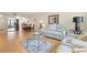 Comfortable living room with modern decor, white sofa and chairs, and light wood floors at 3802 Gulf Of Mexico Dr # A205, Longboat Key, FL 34228