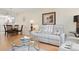 Comfortable living room with modern decor, white sofa, and light wood floors at 3802 Gulf Of Mexico Dr # A205, Longboat Key, FL 34228