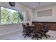 An interior shot of a conference room with natural lighting and rich wood trim at 3802 Gulf Of Mexico Dr # A205, Longboat Key, FL 34228