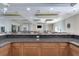 The bar area is visible in the meeting room, which features wood trim and a marble countertop at 3802 Gulf Of Mexico Dr # A205, Longboat Key, FL 34228