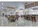 Interior view of a meeting room with a bar and multiple tables and chairs at 3802 Gulf Of Mexico Dr # A205, Longboat Key, FL 34228