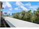 Outdoor parking lot with tropical landscaping, ocean and beach views at 3802 Gulf Of Mexico Dr # A205, Longboat Key, FL 34228