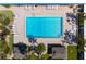 An aerial view of a pristine pool surrounded by lounge chairs and lush landscaping at 3802 Gulf Of Mexico Dr # A205, Longboat Key, FL 34228