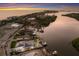 Sunset aerial showcasing home with a private pool, boat dock and canal front at 4 Winslow Pl, Longboat Key, FL 34228