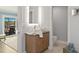 Bathroom featuring a wood vanity with granite counters, and views into the bedroom and waterway at 4 Winslow Pl, Longboat Key, FL 34228