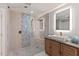 Bathroom featuring glass enclosed shower with mosaic tile, stone floors, and wood vanity with square sink at 4 Winslow Pl, Longboat Key, FL 34228