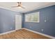 Bedroom with a ceiling fan, a closet and a window with white shutters and wood flooring at 4 Winslow Pl, Longboat Key, FL 34228
