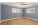 Bedroom with two windows with white shutters, ceiling fan and wood flooring at 4 Winslow Pl, Longboat Key, FL 34228