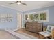 Bedroom suite with a wood dresser, serene decor, plantation shutters and water views at 4 Winslow Pl, Longboat Key, FL 34228