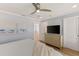 This bedroom has wood floors, a ceiling fan and closet door as well as decor beach themed art at 4 Winslow Pl, Longboat Key, FL 34228