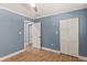 Bedroom featuring wood flooring, a closet and a ceiling fan, with white trim and light blue walls at 4 Winslow Pl, Longboat Key, FL 34228