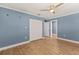 Bedroom featuring a closet, wood flooring, light blue walls, ceiling fan and white trim at 4 Winslow Pl, Longboat Key, FL 34228