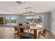 Dining room with wood table and chairs and beautiful views of the water and pool at 4 Winslow Pl, Longboat Key, FL 34228