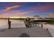 Dock featuring a boat lift and stunning waterfront views, enhancing the property's appeal for boat enthusiasts at 4 Winslow Pl, Longboat Key, FL 34228